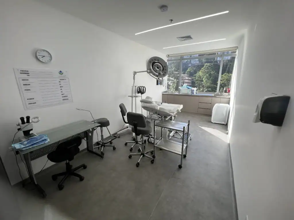 Clean, well-lit healthcare space with examination table, chairs, and medical tools.